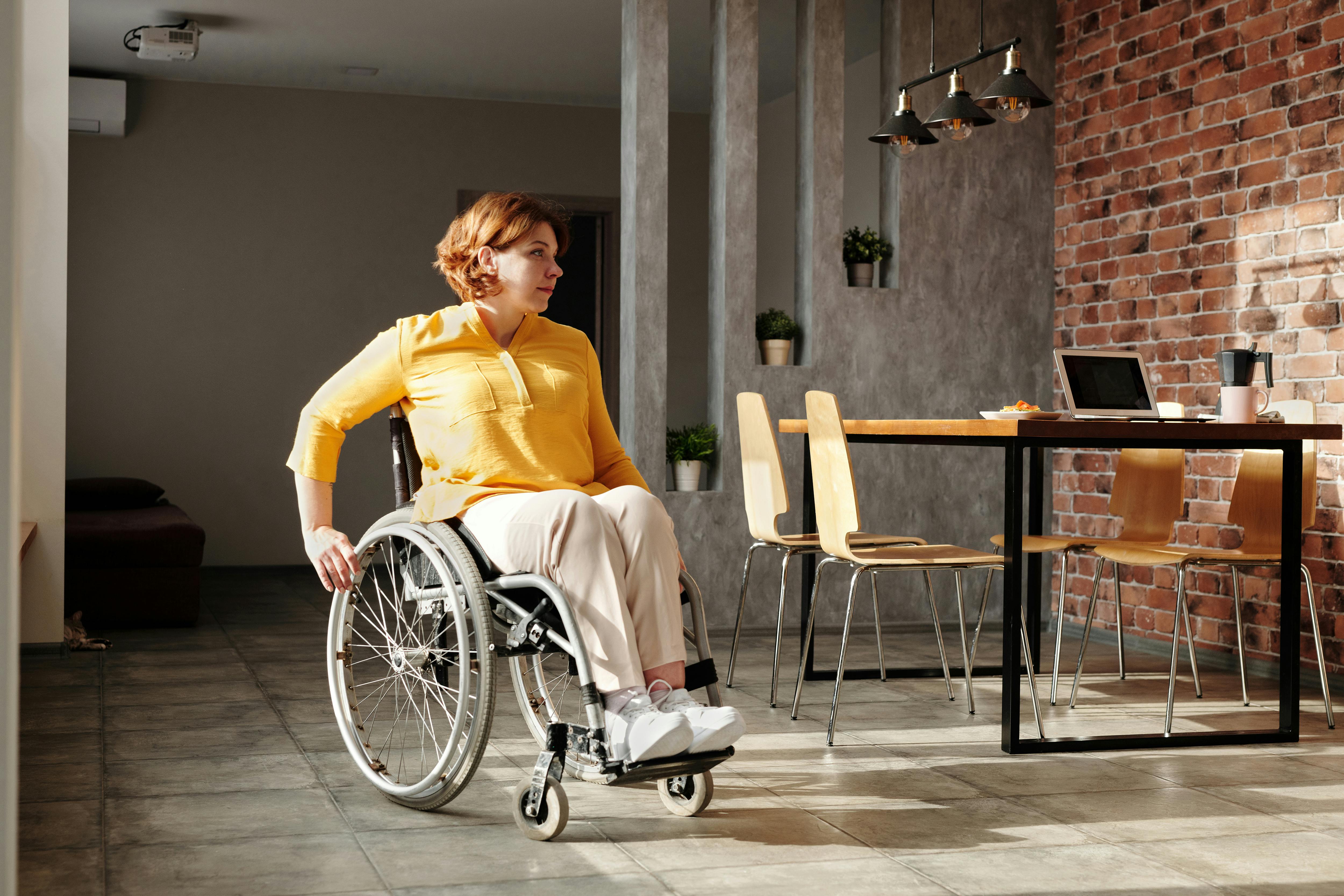 Person in wheelchair in an accessible modern home with open layout